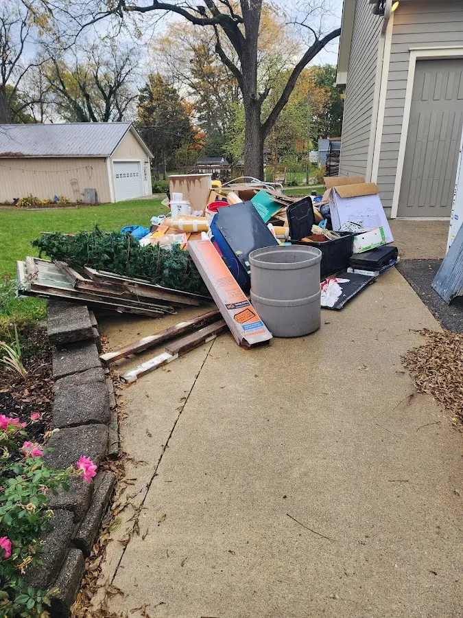 Dumpster being loaded with debris for Commercial Dumpster Rental in St. Charles